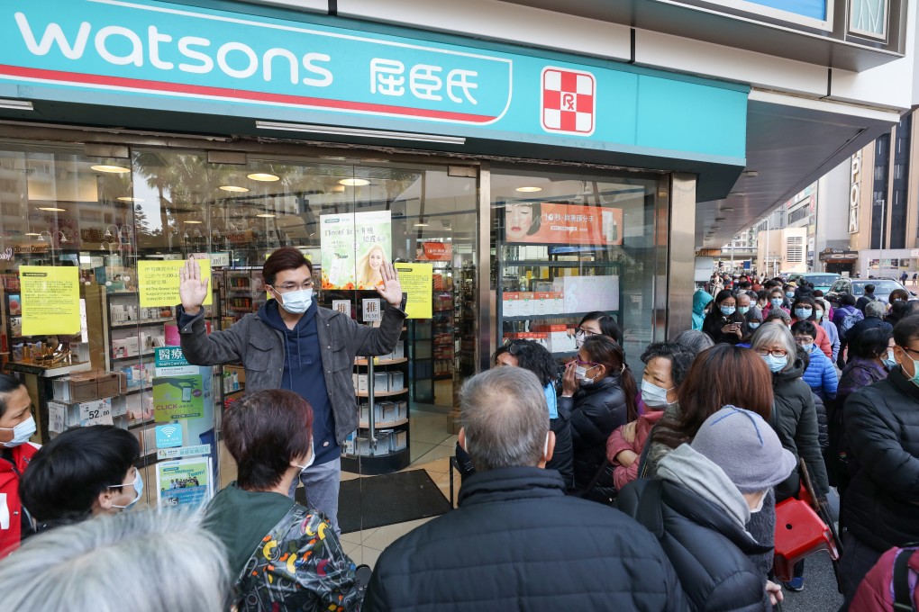 An assistant store manager at the Whampoa Garden branch of Watsons explains the situation to shoppers wanting to buy masks. Photo: Nora Tam
