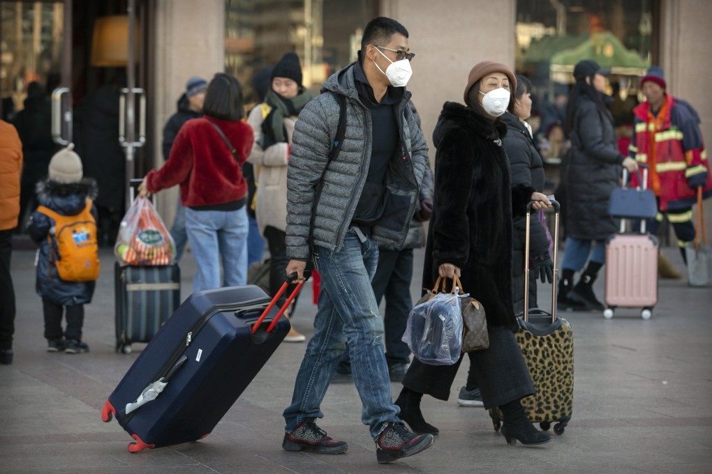 Travelers wear face masks as they walk outside of the Beijing Railway Station, Monday, Jan. 20, 2020. Photo: AP