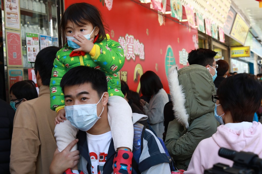 Families are struggling to get hold of surgical masks, leading to long queues outside shops. Photo: May Tse