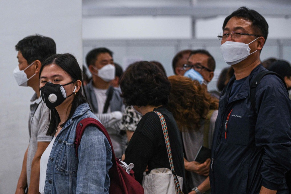 Passengers wearing face masks queue at the immigration counter upon arrival at the Kuala Lumpur International Airport 2 in Sepang on Wednesday. Photo: AFP