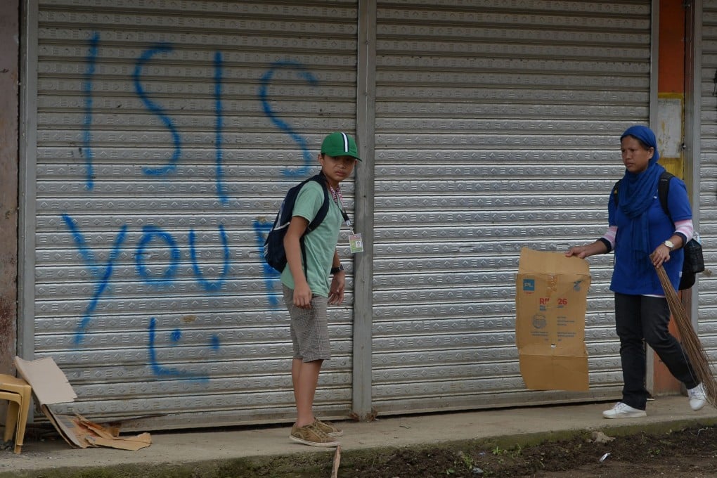 Shops in the Philippines sprayed with pro-Islamic State graffiti. Photo: AFP