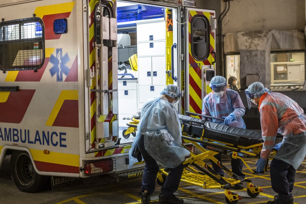 Ambulance workers in protective gear load a stretcher at Queen Mary Hospital in Hong Kong on Wednesday. Photo: Bloomberg