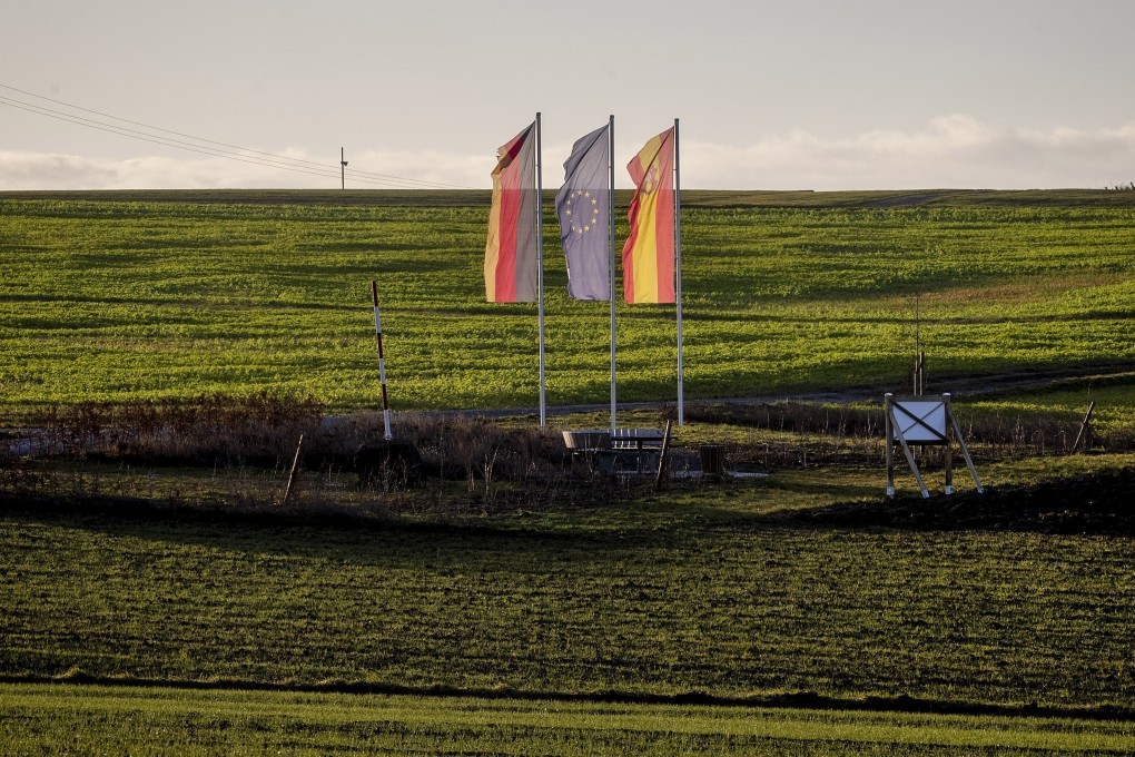 A German, European and local flag, from left, mark the new geographical centre of the EU after the Brexit in Gadheim, southern Germany. Photo: AP