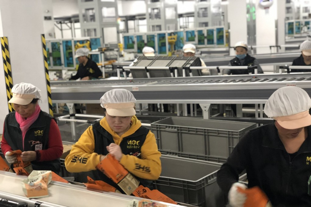 Workers packing snacks along one of the production lines in Three Squirrels’s manufacturing facility in Wuhu, Anhui province on January 23, 2020. Photo: Pearl Liu