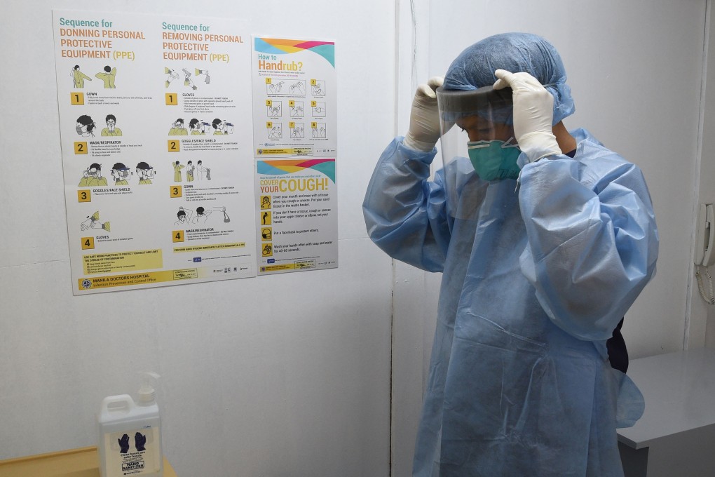 A hospital employee at the Manila Doctors Hospital compound dons protective gear inside the holding area for patients suspected of being infected with the deadly coronavirus. Photo: AFP
