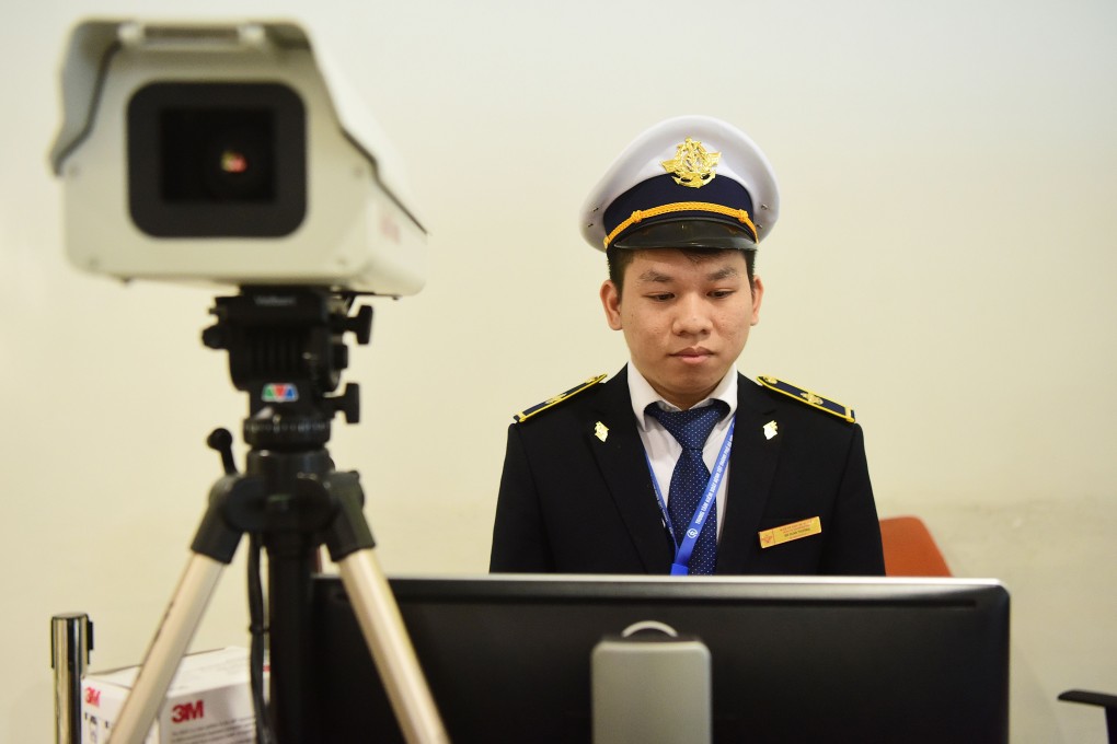 An official mans a thermal scanner at Noi Bai International Airport in Hanoi. Photo: AFP