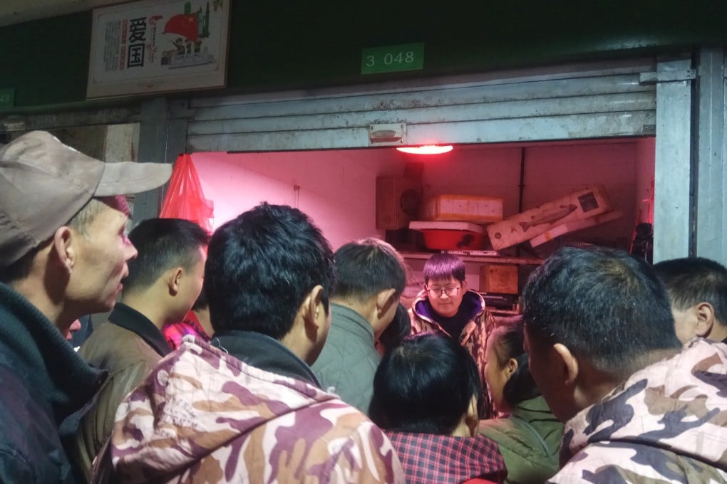 Customers line up outside a store suspected of selling trafficked wildlife in Anji city in Zhejiang on January 17. Chinese law allows the captive breeding of wildlife for commercial purposes, provided that companies obtain a licence from provincial authorities. But such licences are often used to cover up illegal trade. Photo: Anti-Poaching Special Squad via AP