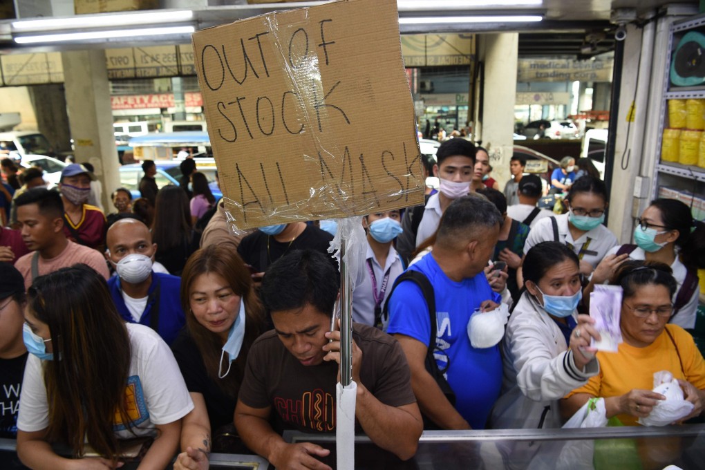 People queue to buy protective masks at a medical supplies store in Manila. Photo: AFP