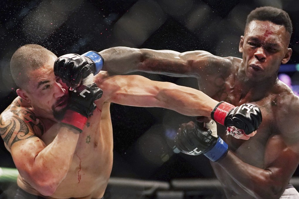 Israel Adesanya (right) throws a right straight at former champion Robert Whittaker at their UFC 243 middleweight unification fight in October last year. Photo: AP