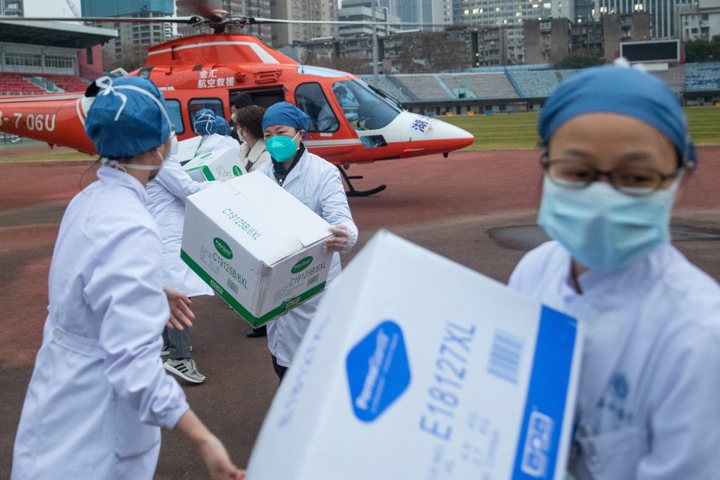 Medical staff unload supplies at Wuhan, where the coronavirus originated. Photo: EPA-EFE