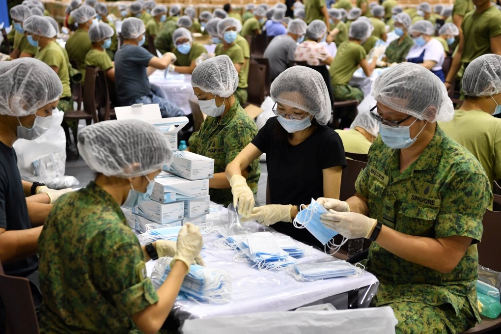Singapore army personnel prepare face masks at SAFTI Military Institute, before distributing them around the country, in Singapore, January 31, 2020. Photo: Handout