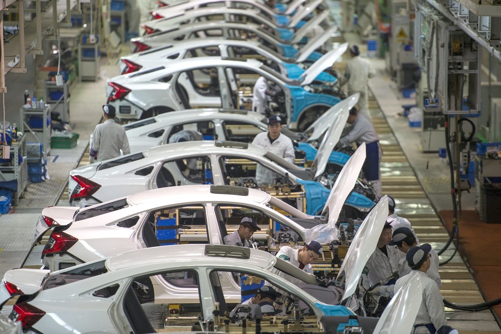Workers assemble Honda Civics on an assembly line at a Dongfeng Honda automotive plant in Wuhan in central China's Hubei province on February 6, 2017. Photo: Chinatopix via AP