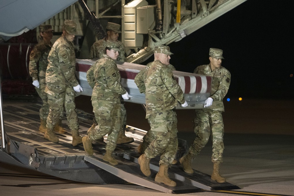 An Air Force carry team moves a transfer case containing the remains of Navy Ensign Joshua Watson, at Dover Air Force Base. Photo: AP Photo