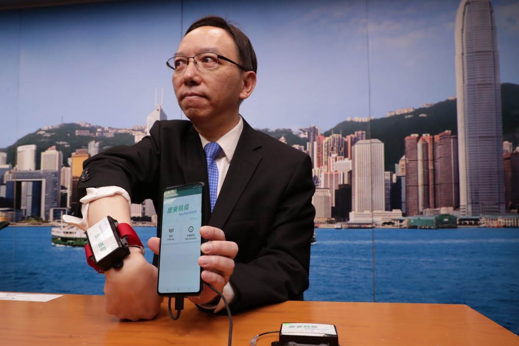Victor Lam, the government’s chief information officer, displays the devices to be used by the quarantined families. Photo: Edmond So