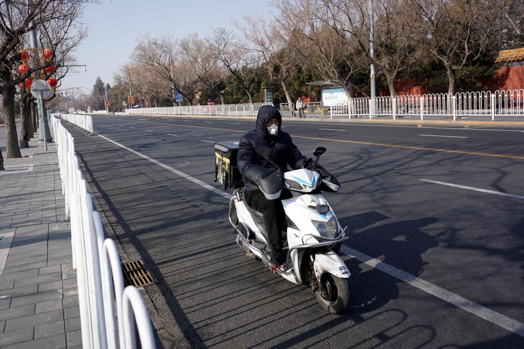 A face mask wearing food delivery rider in Beijing. With people staying indoors during the coronavirus outbreak, companies across a range of sectors are trying new ways to reach their customers. Photo: AFP