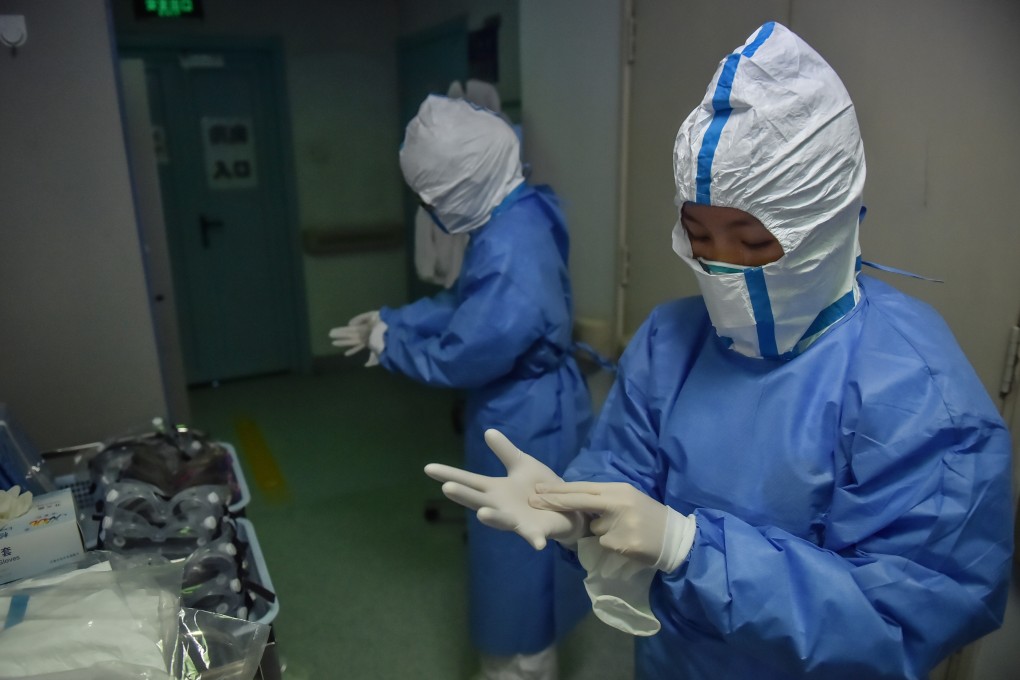 Nurses put on protective suits outside a ward in Beijing Ditan Hospital in Beijing, capital of China, on February 3, 2020. Photo: Xinhua