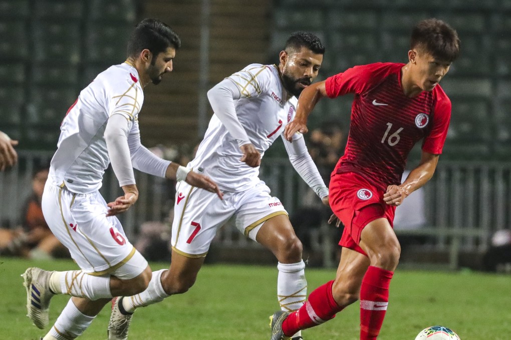 Midfielder Tan Chun-lok breaks away from two Bahrain players in the 2022 World Cup Asian zone qualifiers at Hong Kong Stadium. Photo: May Tse