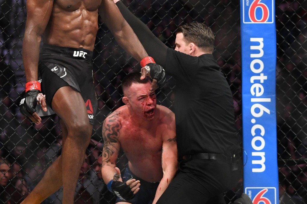 Colby Covington (centre) complains to referee Marc Goddard (right) after he waved off his title fight against champion Kamaru Usman at UFC 245. Photo: USA Today