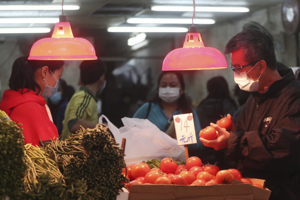 A man shops for tomatoes at a market in Hong Kong on February 3. World food inflation was already heading higher in the fourth quarter of 2019. That trend may continue. Photo: AP