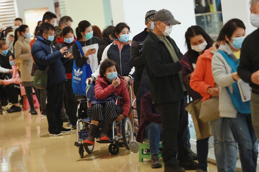People queue for masks at a Watsons shop in Hong Kong. Photo: May Tse