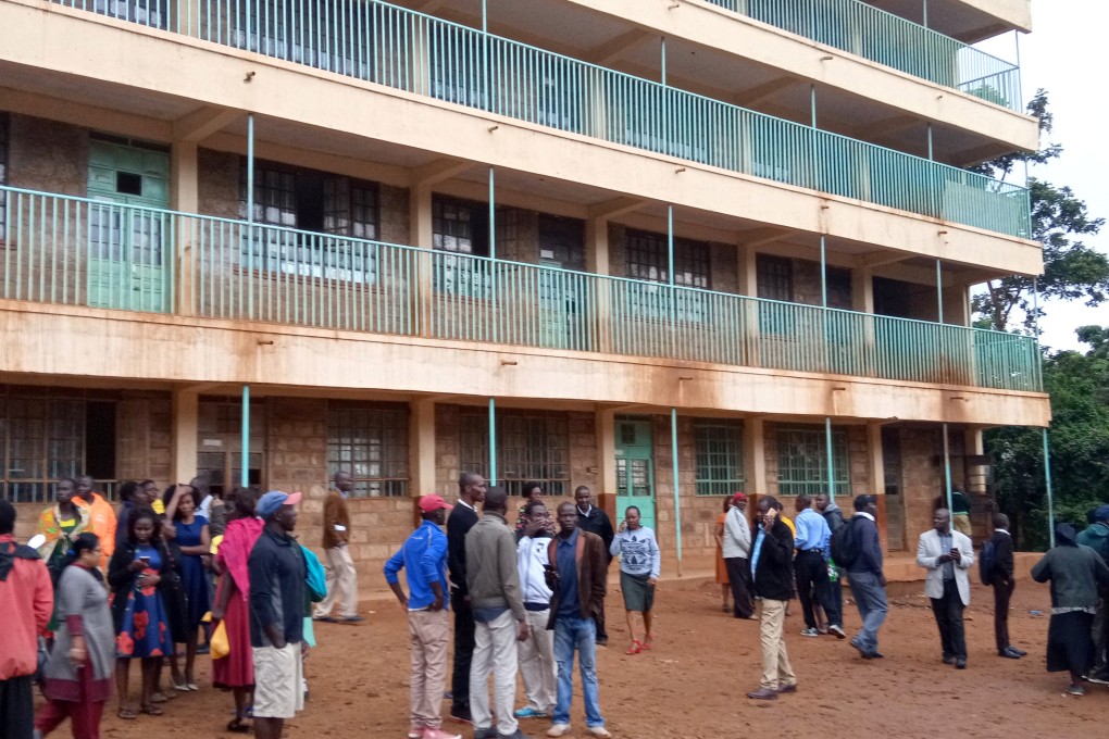 Parents and teachers gather near the scene of a stampede at the Kakamega primary school in Kenya on Monday. Photo: Reuters