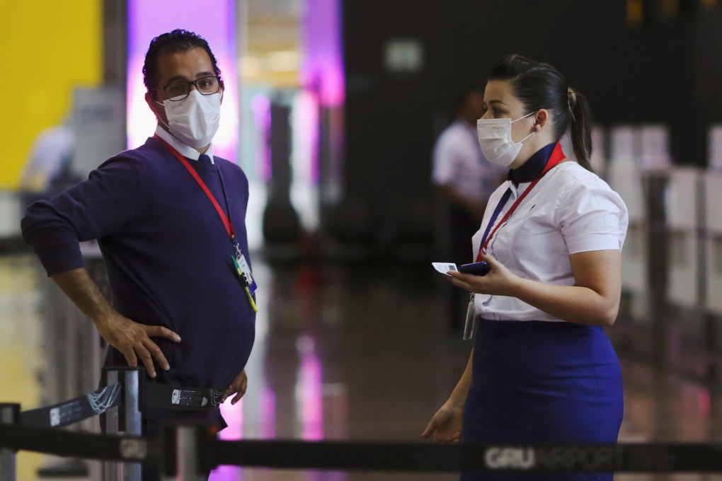 Employees wear masks as a precautionary measure at Guarulhos International Airport in Sao Paulo, Brazil, on Friday. Photo: Reuters