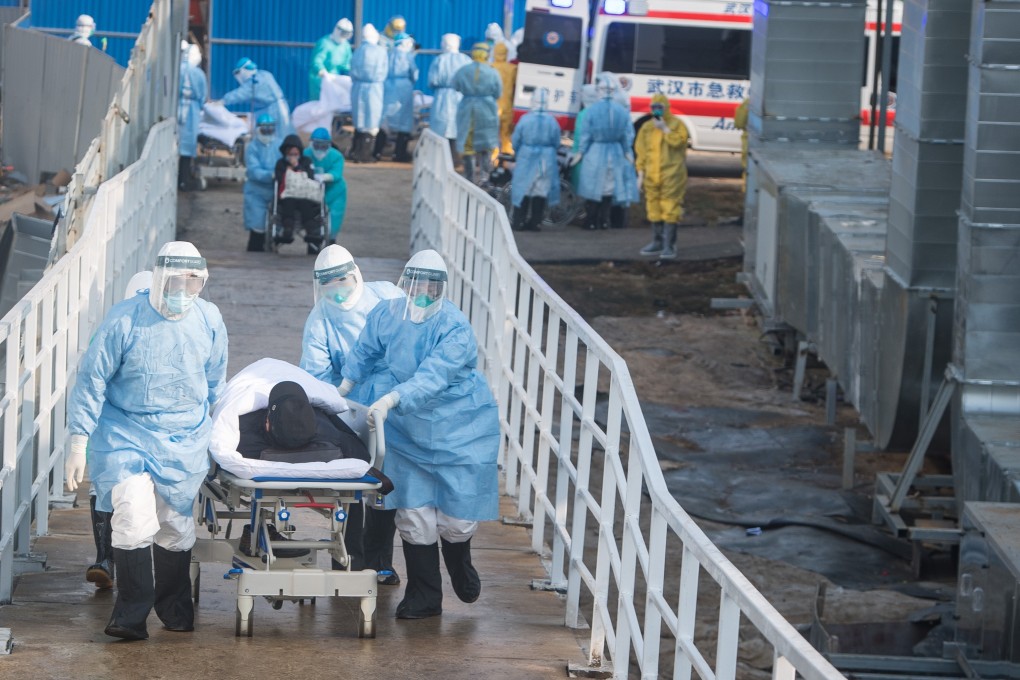 Medical workers move patients to isolation wards at the new Huoshenshan temporary hospital in Wuhan on Tuesday. Photo: Xinhua