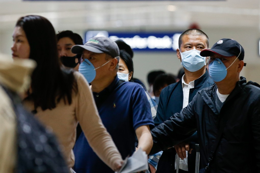 Passengers from Guangzhou, China line up for immigration processing at the Ninoy Aquino International Airport in Manila. Photo: EPA