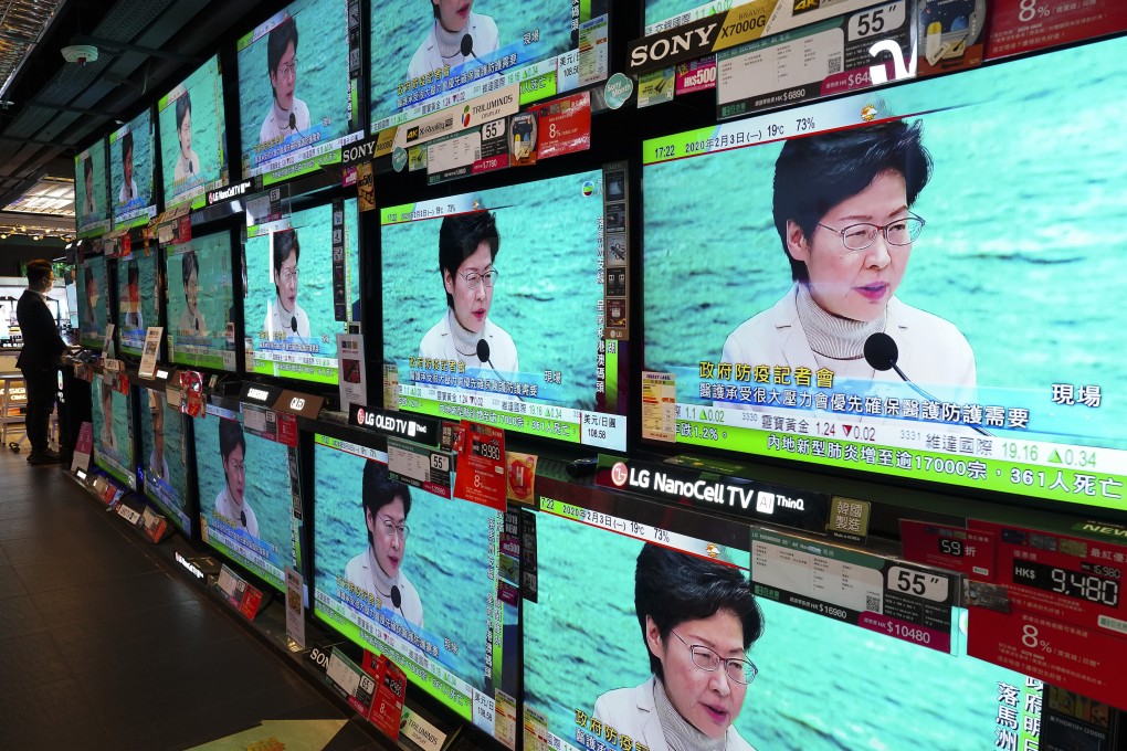 TV screens broadcast Chief Executive Carrie Lam announcing the closure of all but three border crossings with mainland China, in Admiralty on February 3. Photo: Robert Ng