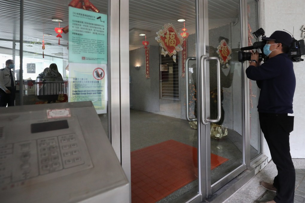 A videojournalist films Block 1 at Whampoa Garden in Hung Hom, where on Tuesday a 39-year-old man became the first person in Hong Kong to die after being diagnosed with the coronavirus. Photo: Nora Tam