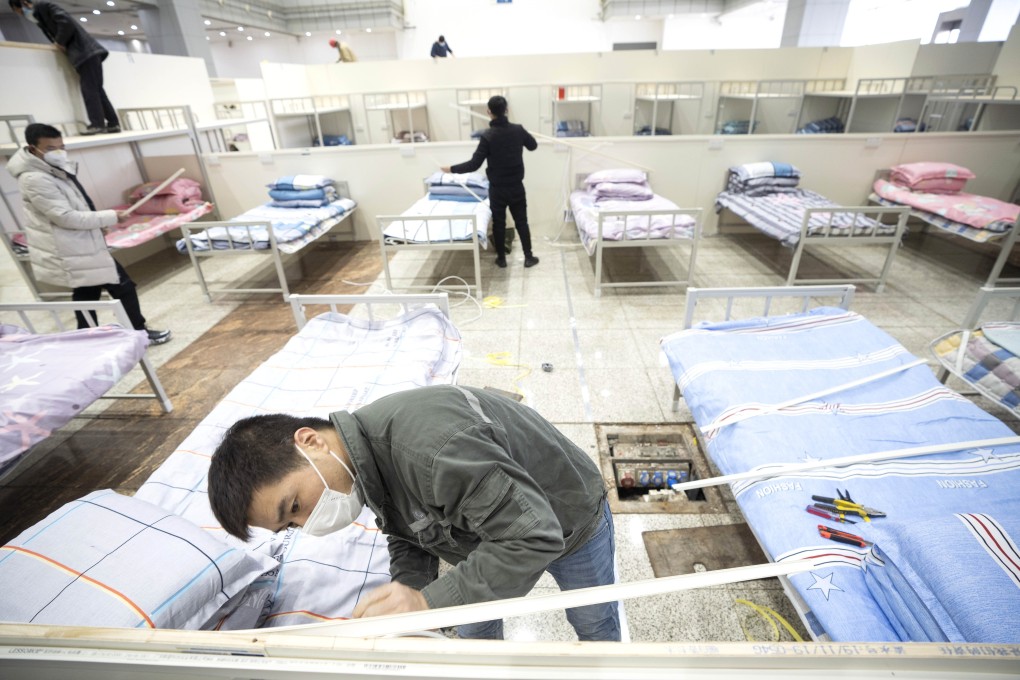 Workers convert the Wuhan International Conference and Exhibition Centre into a temporary hospital on Tuesday. Photo: Xinhua