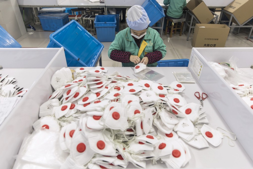 Protective face masks being made at a factory in Shanghai, China. People across the globe are stockpiling masks to protect themselves from the new coronavirus, depleting online malls and store shelves from California to Beijing. Photo: Bloomberg