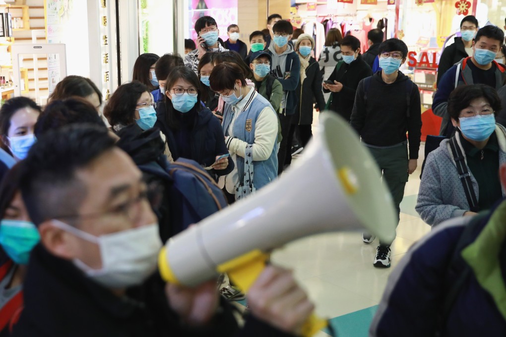 People queue for masks at a store at Kornhill Plaza in Quarry Bay. Photo: May Tse