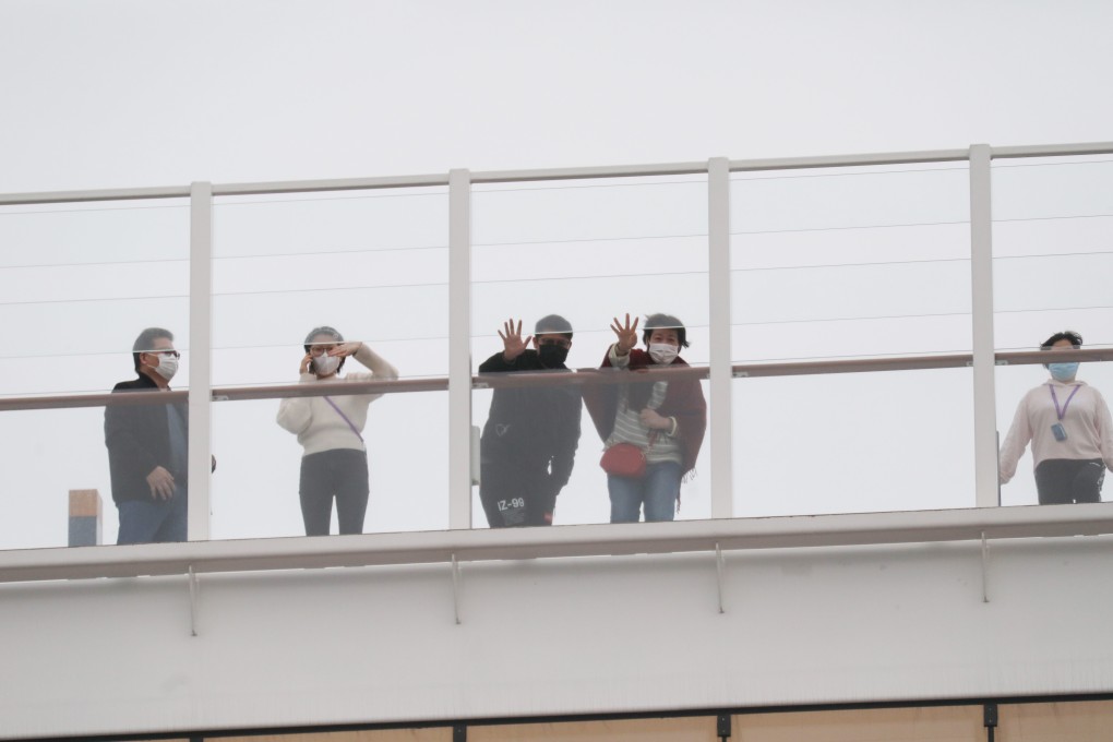 Passengers wave from the deck of the World Dream, which is docked at Kai Tak Cruise Terminal. Photo: Winson Wong