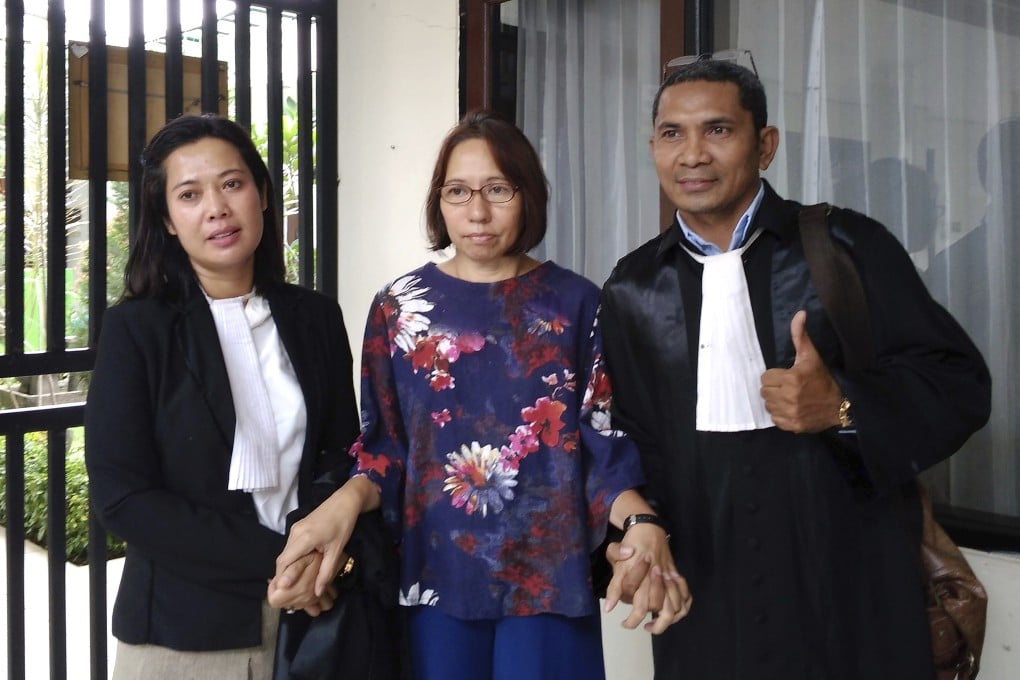 Suzethe Margareth, centre, with her lawyers after her verdict at the Cibinong District Court in West Java, Indonesia. Photo: AP