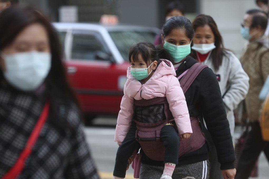 Face masks on young and old, on the streets of Hong Kong on January 31. People around the the region wear masks not only to protect themselves but also to prevent spreading disease. Photo: AP