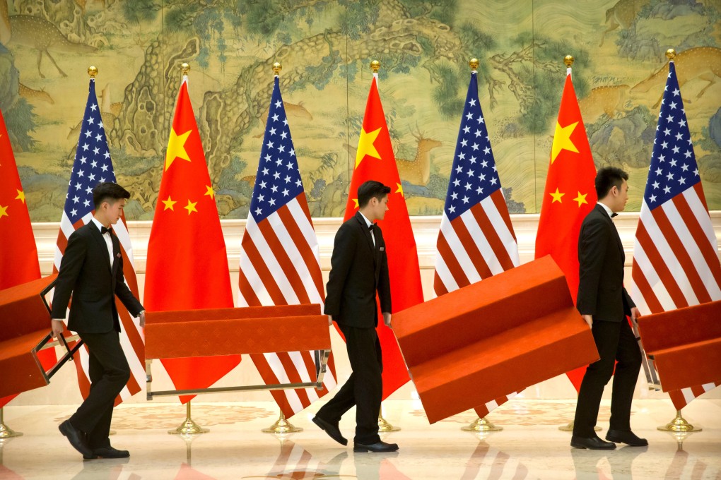 Aides set up platforms before a group photo with members of the US and Chinese trade negotiation delegations at the Diaoyutai State Guesthouse in Beijing on February 15, 2019. Photo: Reuters