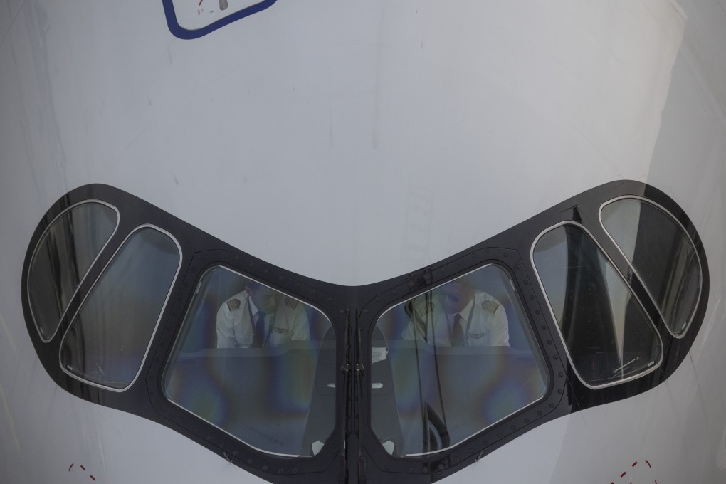 Pilots sit inside the cockpit of a China Eastern aircraft, one of the few mainland carriers to have not made unpaid leave mandatory for foreign pilots. Photo: DPA