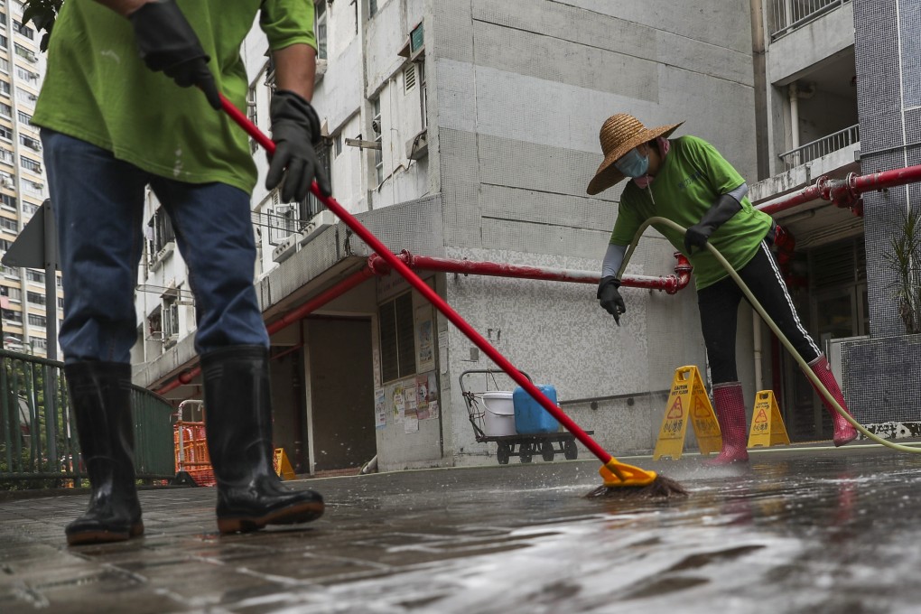 Cleaners wear masks at a Tuen Mun housing estate in Hong Kong. Photo: Sam Tsang