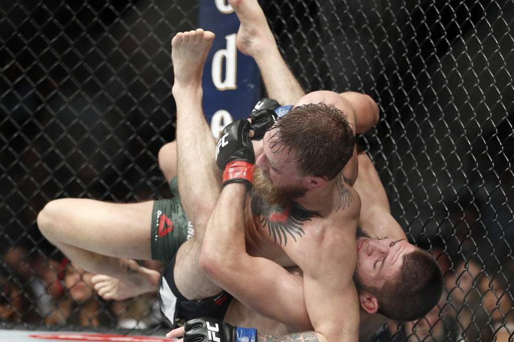 Khabib Nurmagomedov (right) takes Conor McGregor to the ground during his lightweight title win at UFC 229 in 2018. Photo: AP