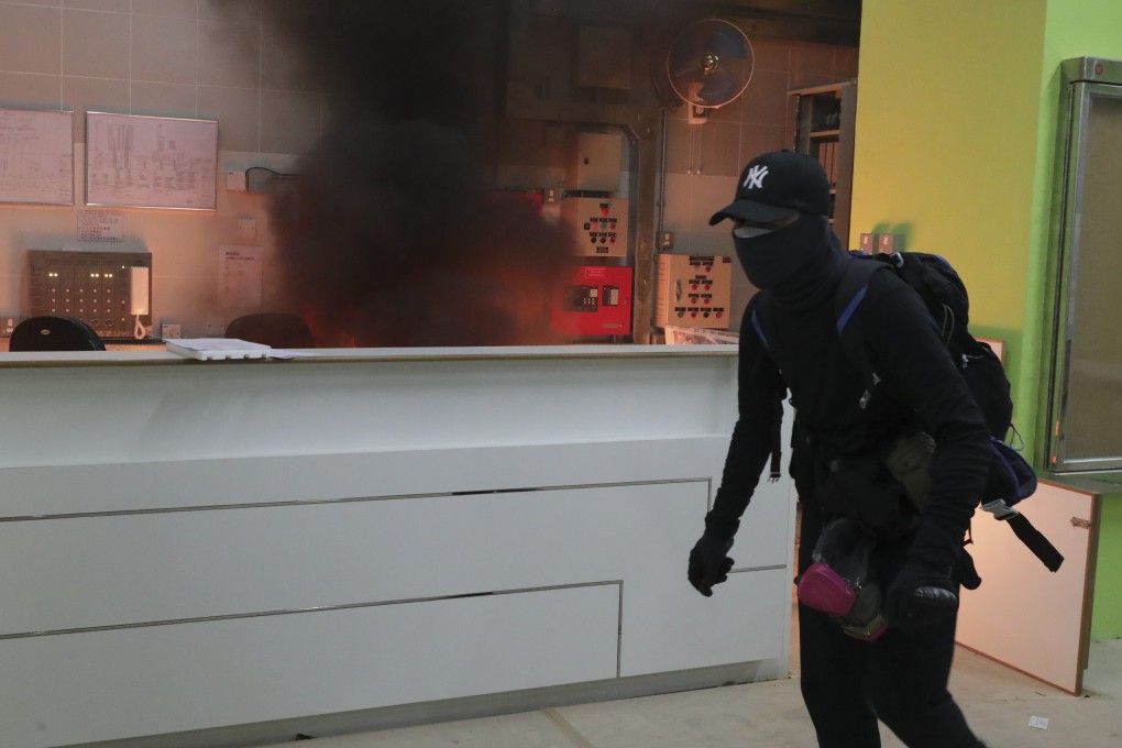 A masked man dressed in black tossed a petrol bomb igniting a fire in the lobby of the Fanling public housing estate the government suggested could serve as a quarantine site for Wuhan coronavirus. Photo: Edmond So