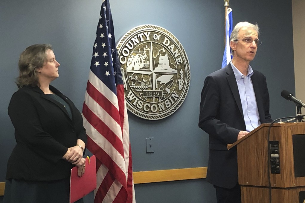 Officials Dane County, Wisconsin, including County Executive Joe Parisi, discuss the confirmed case of coronavirus in a woman from Wisconsin. The mayor of Madison, Satya Rhodes-Conway, looks on during the news conference on Wednesday. Photo: AP