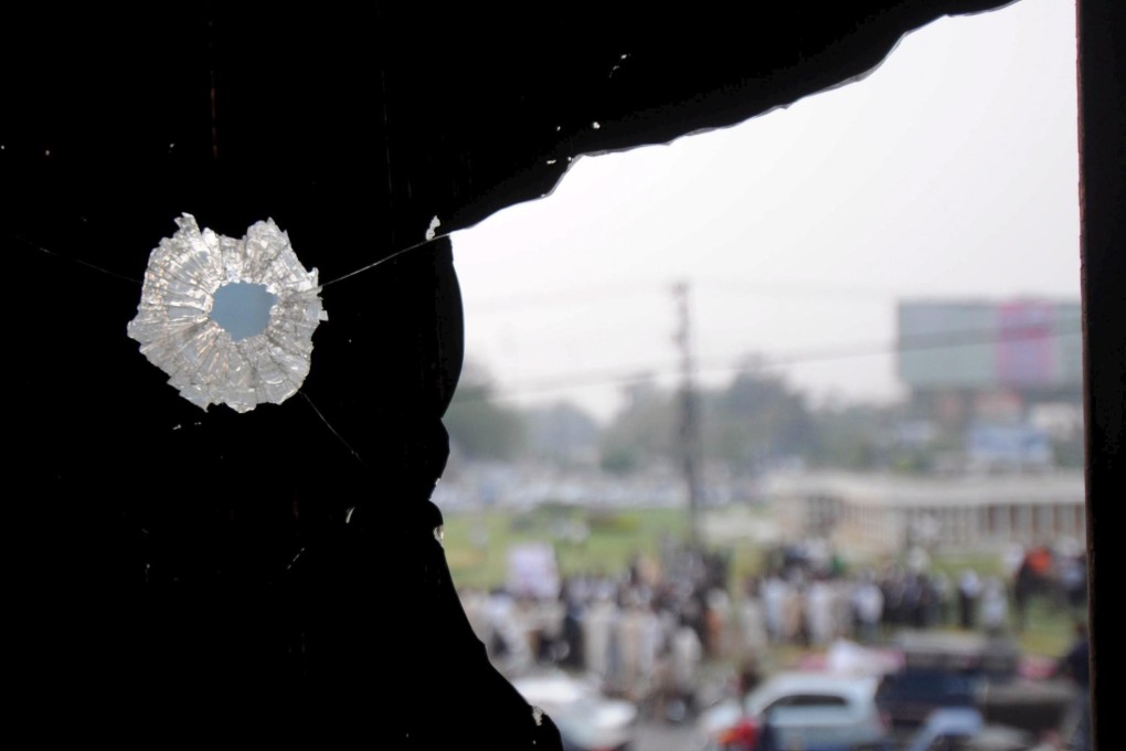 A bullet hole is seen in a broken window near the site of the attack on Sri Lanka’s cricket team in Lahore, Pakistan in 2009. Photo: EPA