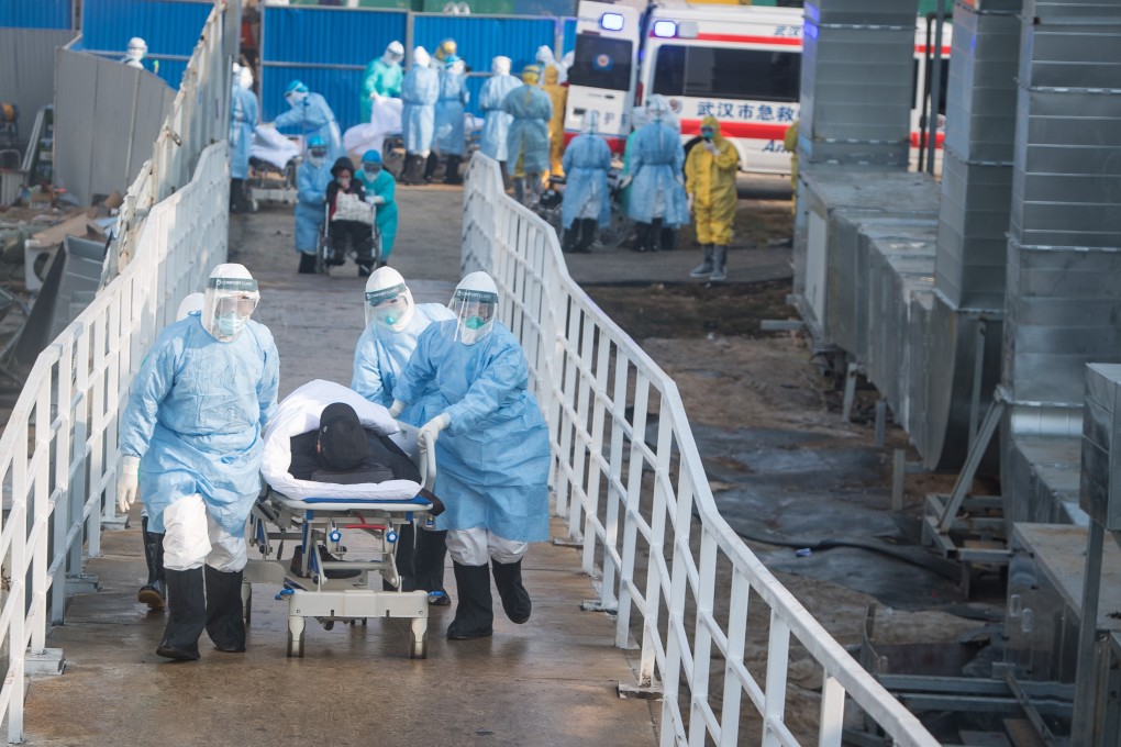Medical workers take coronavirus patients to their isolation wards at the newly built Huoshenshan Hospital in Wuhan, central China's Hubei Province. Photo: Xinhua
