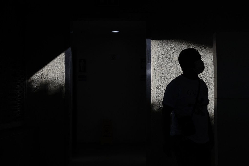 A man wears a protective mask at the arrival area of Manila’s international airport. Photo: AP