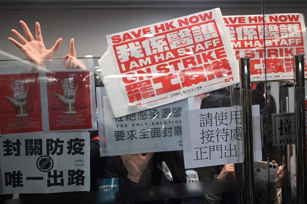 Members of the Hospital Authority Employees Alliance and other medical workers hold placards during a strike at the Hospital Authority building in Hong Kong on February 7. Photo: AFP