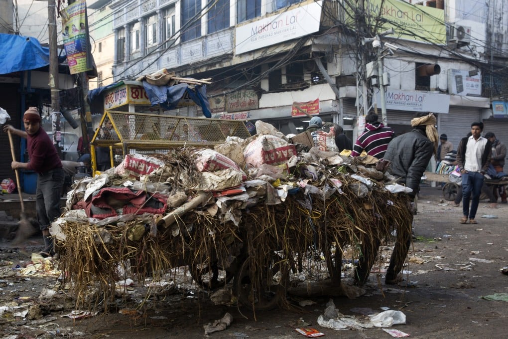 A worker pulls a cart laden with garbage at Chandni Chowk market in New Delhi, India. Prime Minister Narendra Modi’s budget has disappointed investors who were hoping for stimulus to revive growth in Asia’s third-largest economy. Photo: Bloomberg