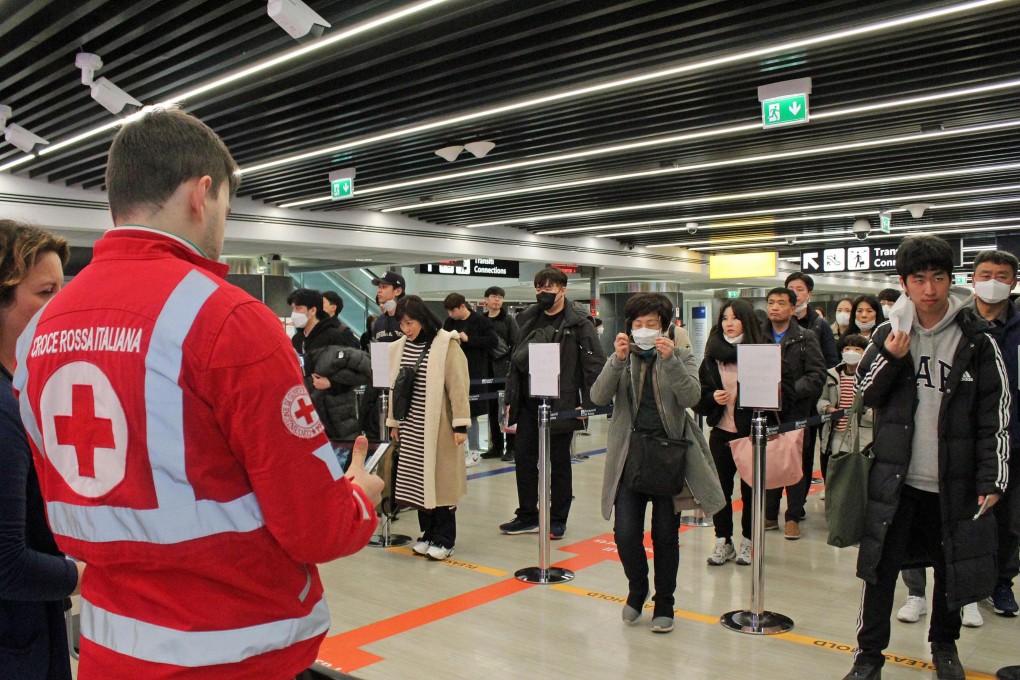 Staff at Leonardo Da Vinci airport, Rome check the temperature of arrive passengers. Photo: EPA-EFE