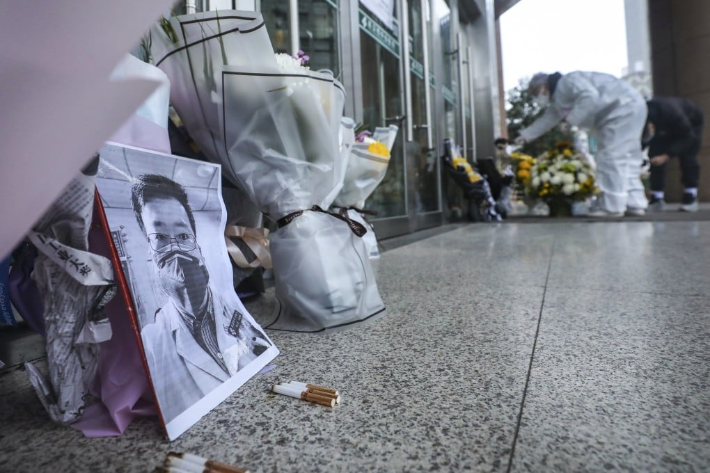 Tributes to Li Wenliang lie outside the doors of Wuhan Central Hospital in Wuhan, Hubei province, on Friday. Photo: AP