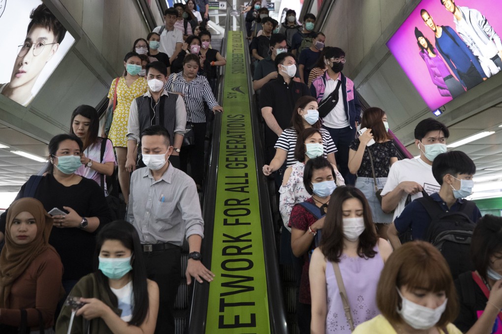 Commuters wear face masks at a skytrain station in Bangkok on February 7, 2020. Photo: AP